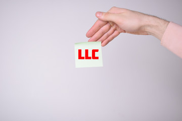 A businessman shows an inscription:LLC