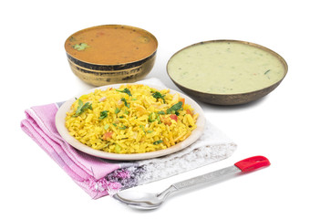 Indian Breakfast Dish Poha Also Know as Pohe or Aalu poha made up of Beaten Rice or Flattened Rice. The rice flakes are lightly fried in oil with mustard, chilly, onion, curry leaves and turmeric