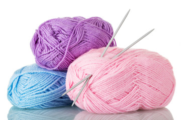 Soft colored balls of yarn and knitting needles, isolated on white
