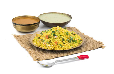 Indian Breakfast Dish Poha Also Know as Pohe or Aalu poha made up of Beaten Rice or Flattened Rice. The rice flakes are lightly fried in oil with mustard, chilly, onion, curry leaves and turmeric