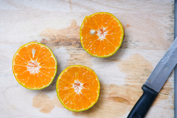 Fresh slices of orange on wooden table