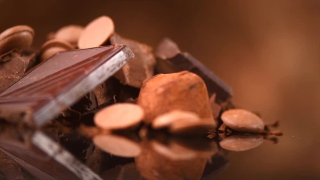 Chocolate. Assorted chocolate sweets and candies over dark background. Confectionery. 4K UHD video 3840X2160