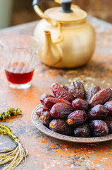 Close up of medjoul - dried dates or kurma in a vintage plate.