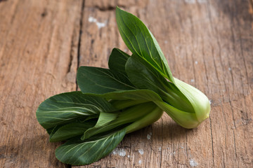 Pak Choy, fresh chinese cabbage on wood background