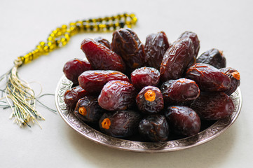 Close up of medjoul - dried dates or kurma in a vintage plate.