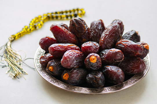 Close up of medjoul - dried dates or kurma in a vintage plate.