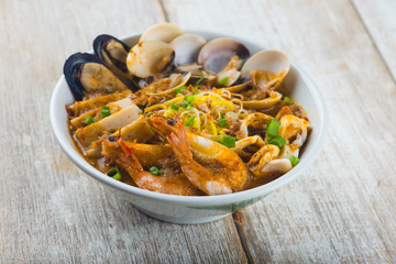 seafood curry noodle with wood background