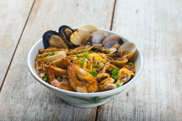 seafood curry noodle with wood background