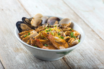 seafood curry noodle with wood background