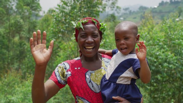 Mother and daughter waving hands