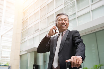 senior asian business man on a phone