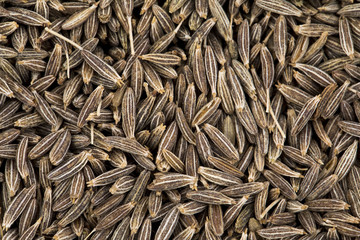 Background Texture of Dried Cumin Seeds Also Know as Caraway, jira or jeera Its seeds are used in the cuisines of many different cultures