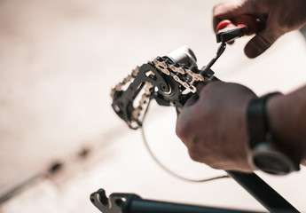 A guy athlete serves and repairs his mountain bike in the garage