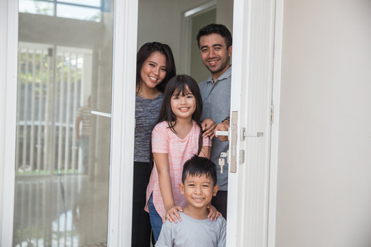 Happy Family With Kids Open Their House Door 