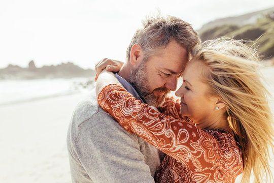 Loving senior couple embracing on the beach