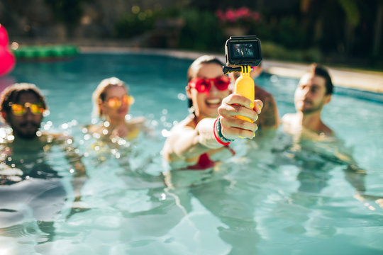 Friends taking selfie at pool party