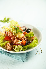 Homemade pasta salad with cherry tomatoes and olives