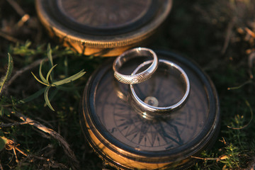 gold rings on an ancient metal compass