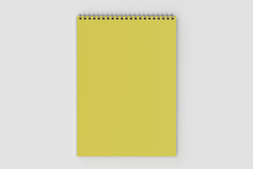 Blank yellow notebook with metal spiral bound on white background