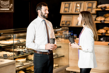 Fototapeta na wymiar Business couple talking near the counter of the coffee shop