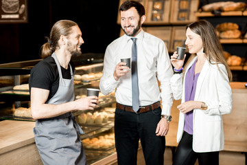 Business couple with barista in the shop