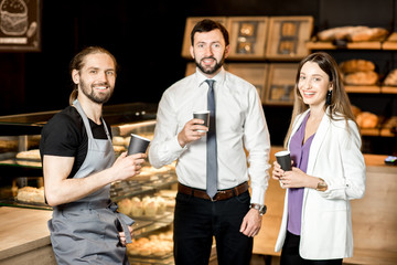 Business couple with barista in the shop