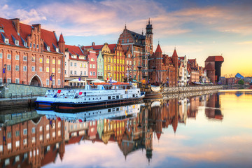 Fototapeta na wymiar Beautiful old town of Gdansk reflected in Motlawa river at sunrise, Poland.