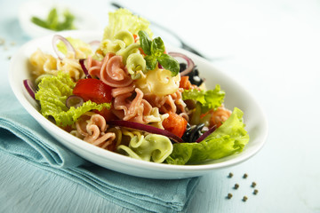 Homemade pasta salad with cherry tomatoes and olives