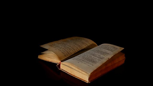 Open book rotate on a black background