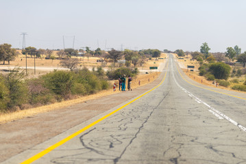 Poor people walking on the roadside in the rural Caprivi Strip, the most populated region in...