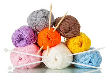 Skeins of multicolored yarn and needles for hand knitting isolated on white