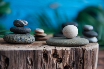 Pyramids of gray zen stones with white candle. Concept of harmony, balance and meditation, spa, massage, relax