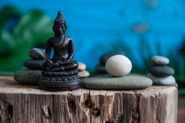 Pyramids of gray zen stones with white candle. Concept of harmony, balance and meditation, spa, massage, relax