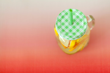 Homemade citrus lemonade in a glass jar, view from the top. Copy space on the left.
