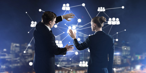 Concept of social connection and networking against night city view and partners working in cooperation