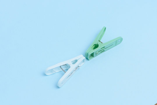 Cloths pegs isolated on light color background.