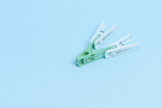 Cloths pegs isolated on light color background.