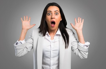 Pretty woman making surprise gesture on grey background