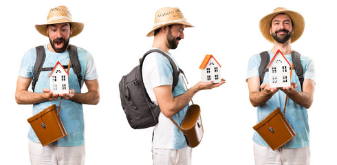 Set of Funny tourist holding a little house