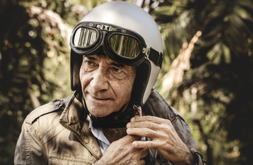 Mature man putting on a helmet