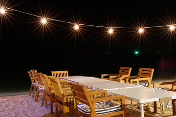 Dining table seaside at night. Summer holiday concept.