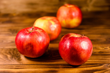 Ripe red apples on the wooden table