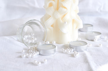 candle, white beads and glass bowl