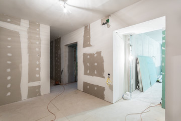 Metal frames and plasterboard -drywall- for gypsum walls   and electric wires  in apartment is...