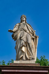 Fototapeta na wymiar Old Sculpture in front of a blue sky