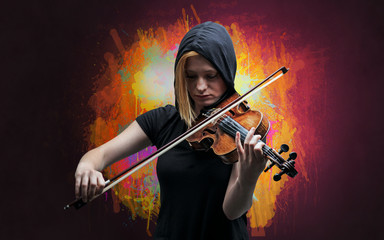 Fototapeta premium Young classical violinist musician with colorful splotch wallpaper 