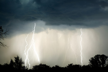 Lightning in the night with red sky during stormy weather