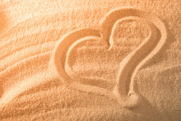 Fototapeta na wymiar Heart in the sand on the beach. Love symboll.