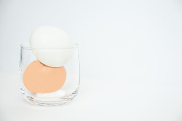 peeled boiled eggs in glass isolated on white background