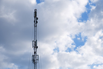 Obraz premium Mobile phone cellular tower silhouette with blue sky.